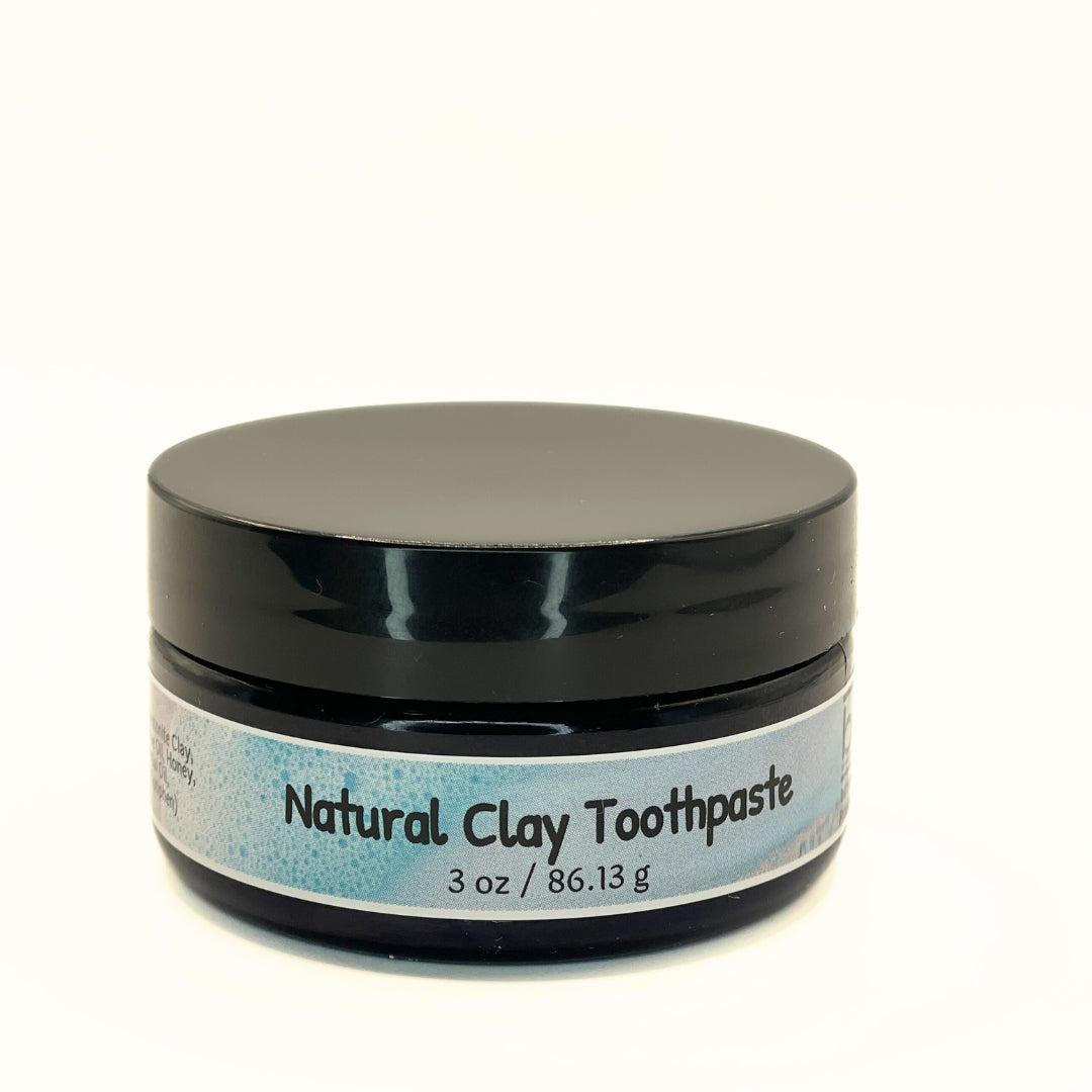Tube of Natural Clay Toothpaste with peppermint and honey, highlighting its natural ingredients.