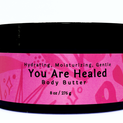 Jar of You Are Healed Body Butter showing its rich, creamy texture and elegant packaging.