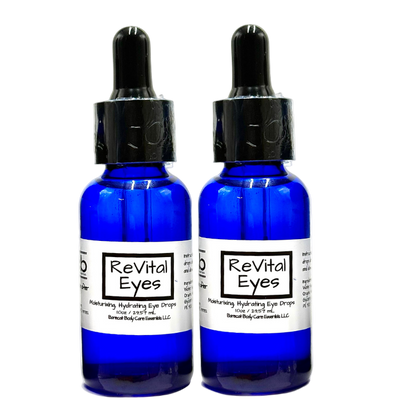 Two blue bottles of 'Revital Eyes' on a white background